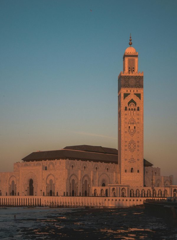 Stunning view of Hassan II Mosque against the sunset sky in Casablanca, Morocco.