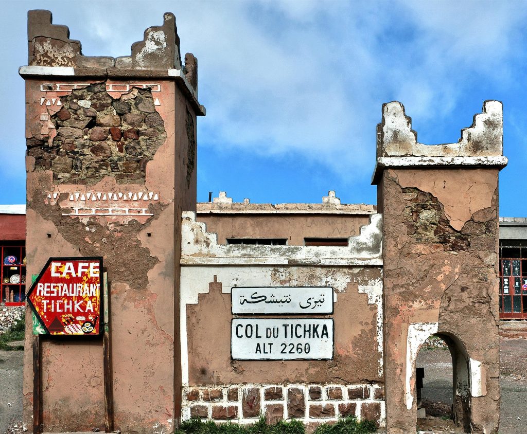 Historic Col du Tichka sign and structure on a sunny day in Morocco.
