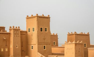 Traditional earthen architecture with towers, showcasing historical fortifications.