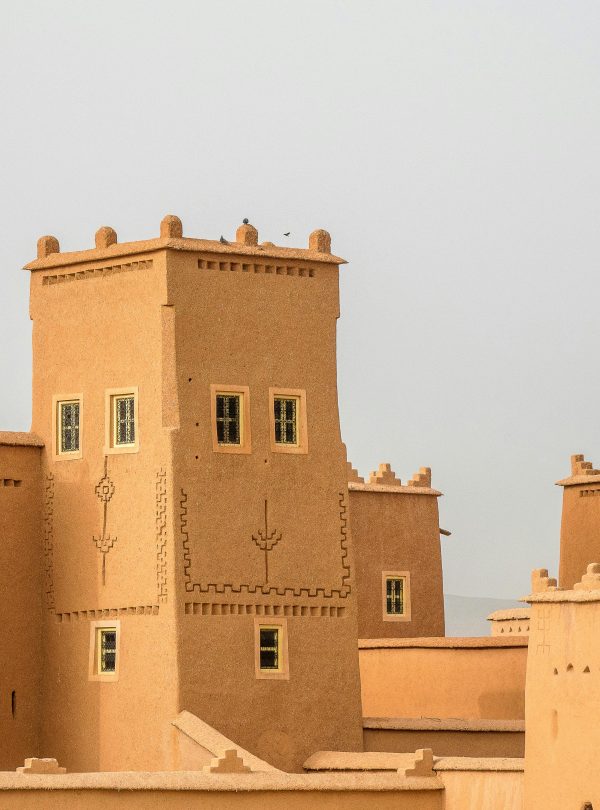 Traditional earthen architecture with towers, showcasing historical fortifications.
